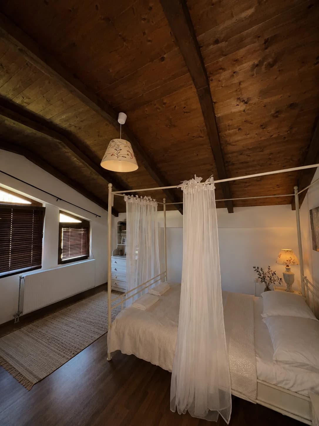 Upper-floor bedroom with a canopy bed